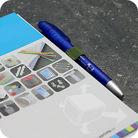 legatoria Portapenne grosse, autoadesivo elastico, OLIVA.  Per penne grosse (circonferenza 3-4cm). Dimensioni lembo adesivo: 45x30mm..