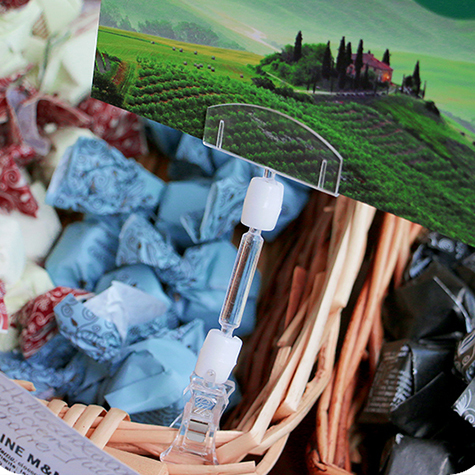 legatoria Doppia molletta Piccola-Portacartellino altezza 130mm TRASPARENTE in policarbonato. Composta da 2 mollette, 1 PICCOLA (38x21mm) e 1 PORTACARTELLINO (50x15mm) collegate da DOPPIO giunto a sfera e gambetto da 38mm. Altezza totale 130mm.