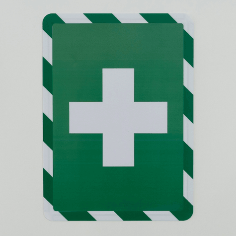 legatoria Cornice per segnalazioni antinfortunistiche, A4 VERDE-BIANCO. AUTOADESIVA mediante nastro biadesivo in schiuma di PE, largo: 19mm, spessore: 1mm. Il foglio protettivo trasparente antiriflesso  adeso con nastro magnetico di larghezza 7 mm. Per fogli di dimensione A4 (210x297mm). Dimensioni esterne: 230x318mm. Area visibile: 200x288. Altezza profilo: 25mm..