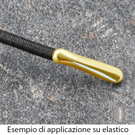 legatoria Capicorda a -T- per elastico o cordoncino OTTONATO, lunghezza 14,3mm. Larghezza 3,2mm. Spessore 3,5mm. Per elastico di spessore fino a 3mm..
